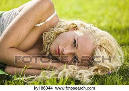 Portrait of young woman lying View Large Photo Image Picture - Portrait of young woman lying. Fotosearch