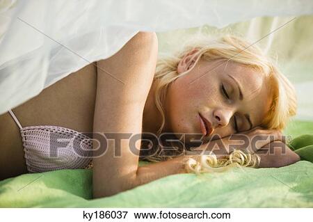Stock Photo - Portrait of young woman lying. Fotosearch