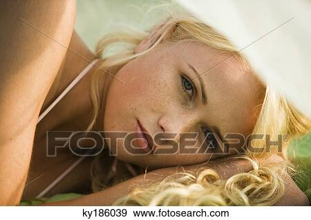 Portrait of young woman lying View Large Photo Image Stock Photo - Portrait of young woman lying. Fotosearch