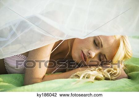 Stock Image - Portrait of young woman sleeping. Fotosearch