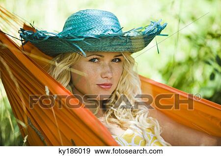 Young woman in a hammock View Large Photo Image Stock Photo - Young woman in a hammock. Fotosearch