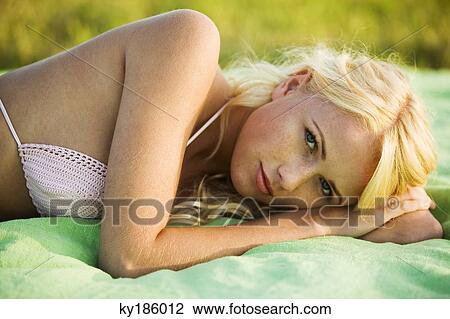 Stock Image - Young woman lying. Fotosearch