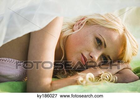 Young woman lying View Large Photo Image Stock Photo - Young woman lying. Fotosearch