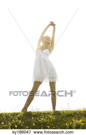 Young woman stretching herself View Large Photo Image Stock Photo - Young woman stretching herself. Fotosearch