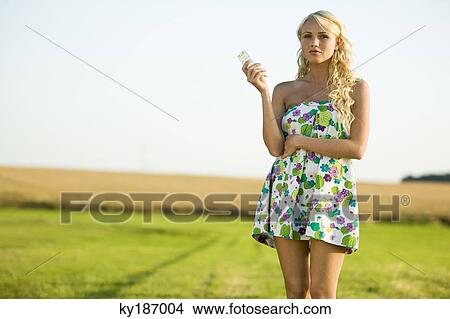 Young woman holding a cell View Large Photo Image Picture - Young woman holding a cell. Fotosearch