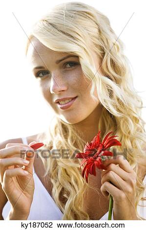 Young woman holding a red gerbera View Large Photo Image Stock Image - Young woman holding a red gerbera. Fotosearch