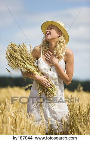 Young woman in wheat field View Large Photo Image Picture - Young woman in wheat field. Fotosearch
