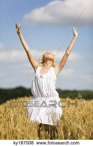 Young woman in wheat field View Large Photo Image Stock Photo - Young woman in wheat field. Fotosearch