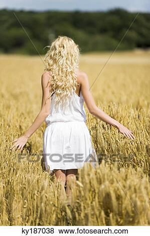 Young woman in wheat field View Large Photo Image Stock Photo - Young woman in wheat field. Fotosearch