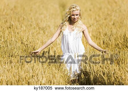 Young woman in wheat field View Large Photo Image Stock Photography - Young woman in wheat field. Fotosearch
