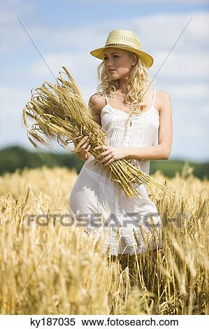 Young woman in wheat field View Large Photo Image Stock Photography - Young woman in wheat field. Fotosearch