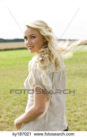 Young woman, outdoors View Large Photo Image Stock Image - Young woman, outdoors. Fotosearch