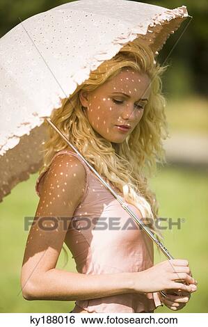 Stock Photograph - Young woman holding an umbrella. Fotosearch