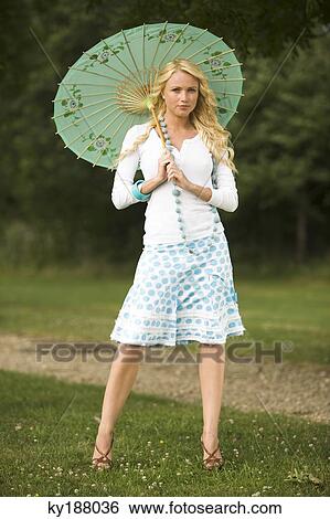 Stock Photograph - Young woman holding an umbrella. Fotosearch