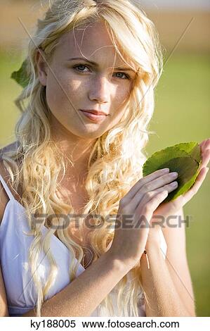 Young woman holding green leaves View Large Photo Image Stock Photography - Young woman holding green leaves. Fotosearch