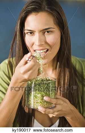 Portrait of a woman eating bean sprouts View Large Photo Image Stock Photo - Portrait of a woman eating bean sprouts. Fotosearch