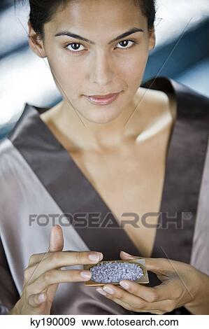 Woman holding a container of bath salt View Large Photo Image Stock Photo - Woman holding a container of bath salt. Fotosearch