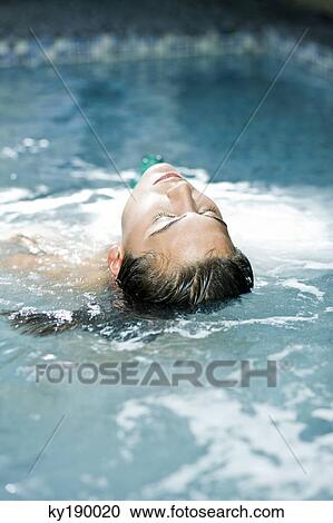 Stock Image - Woman in a swimming pool. Fotosearch