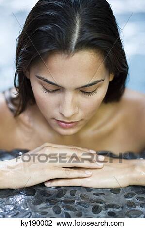 Woman leaning at the poolside View Large Photo Image Stock Image - Woman leaning at the poolside. Fotosearch
