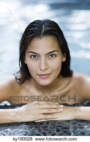 Woman leaning at the poolside View Large Photo Image Stock Photo - Woman leaning at the poolside. Fotosearch