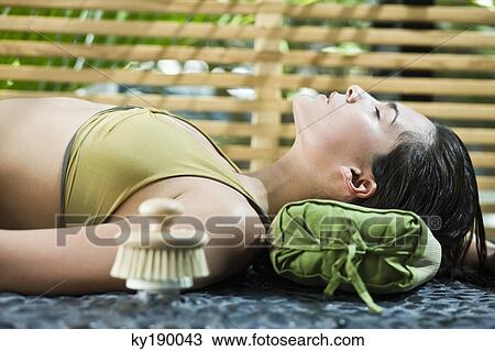 Woman resting at the poolside View Large Photo Image Stock Image - Woman resting at the poolside. Fotosearch