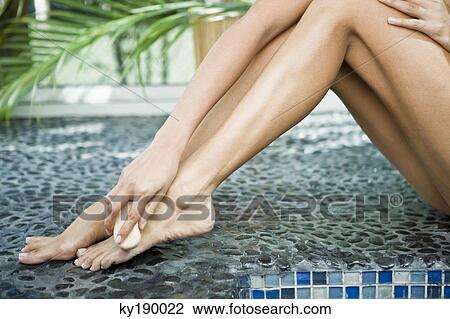 Woman rubbing her foot with a brush View Large Photo Image Stock Image - Woman rubbing her foot with a brush. Fotosearch