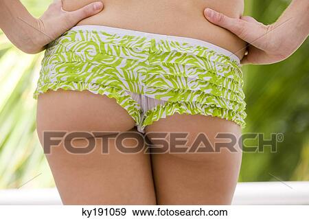 Mid section view of a woman standing with arms akimbo View Large Photo Image Stock Photo - Mid section view of a woman standing with arms akimbo. Fotosearch