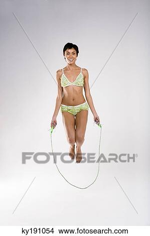 Portrait of a woman skipping with a rope View Large Photo Image Picture - Portrait of a woman skipping with a rope. Fotosearch