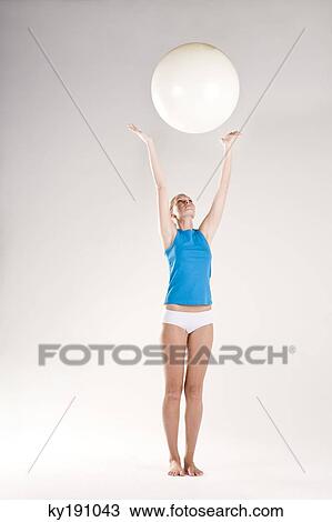 Woman exercising with a fitness ball View Large Photo Image Stock Image - Woman exercising with a fitness ball. Fotosearch