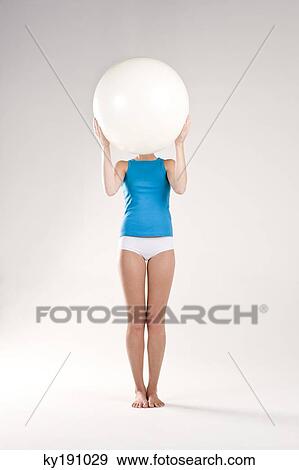 Stock Photo - Woman exercising with a fitness ball. Fotosearch