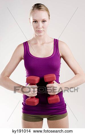 Woman exercising with dumbbells View Large Photo Image Picture - Woman exercising with dumbbells. Fotosearch