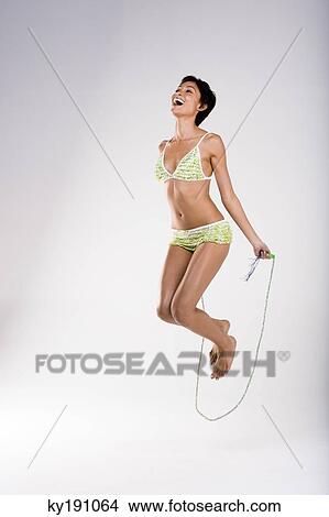 Picture - Woman skipping with a rope. Fotosearch
