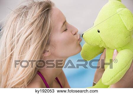 Close-up of a woman kissing a teddy bear View Large Photo Image Stock Image - Close-up of a woman kissing a teddy bear. Fotosearch