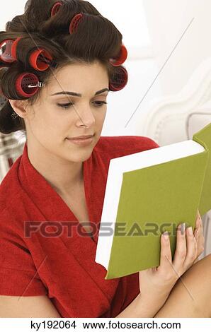 Close-up of a woman reading a book View Large Photo Image Picture - Close-up of a woman reading a book. Fotosearch