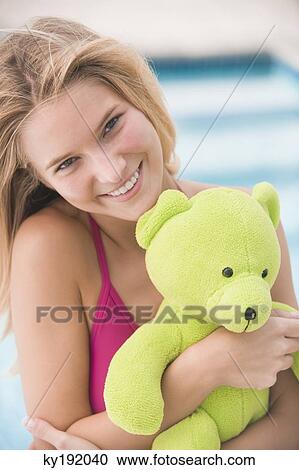 Portrait of a woman holding a teddy bear and smiling View Large Photo Image Stock Image - Portrait of a woman holding a teddy bear and smiling. Fotosearch