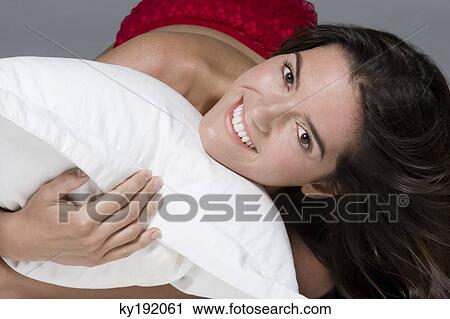 Portrait of a woman hugging a pillow and smiling View Large Photo Image Stock Image - Portrait of a woman hugging a pillow and smiling. Fotosearch