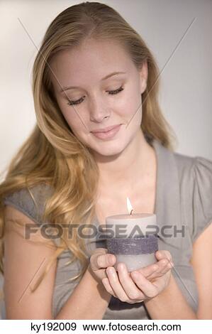 Woman holding a burning candle View Large Photo Image Stock Photo - Woman holding a burning candle. Fotosearch