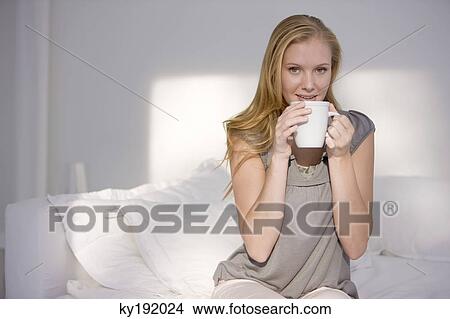Woman holding a cup of coffee View Large Photo Image Picture - Woman holding a cup of coffee. Fotosearch
