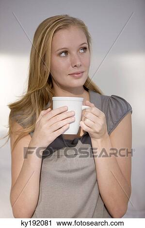 Woman holding a cup of coffee View Large Photo Image Stock Image - Woman holding a cup of coffee. Fotosearch