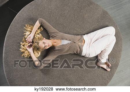 Woman lying on a round sofa View Large Photo Image Stock Photo - Woman lying on a round sofa. Fotosearch