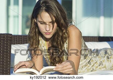 Stock Image - Woman reading a book. Fotosearch