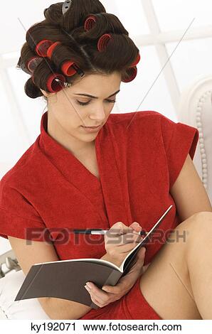 Woman writing in a notebook View Large Photo Image Stock Image - Woman writing in a notebook. Fotosearch