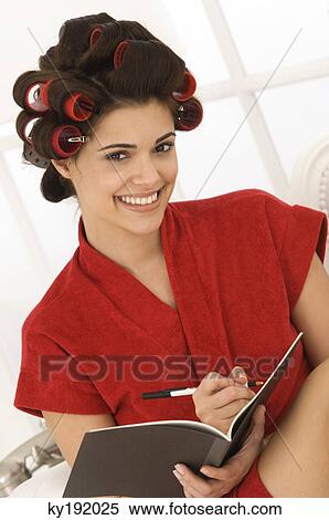Stock Photography - Woman writing in a notebook. Fotosearch