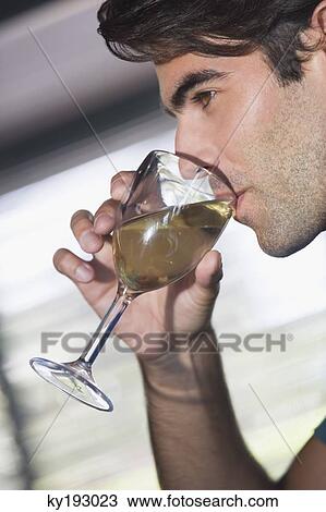 Close-up of a man drinking wine from a glass View Large Photo Image Stock Image - Close-up of a man drinking wine from a glass. Fotosearch