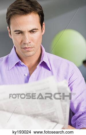 Close-up of a man reading a newspaper View Large Photo Image Picture - Close-up of a man reading a newspaper. Fotosearch