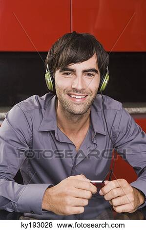 Man listening to an MP3 player View Large Photo Image Stock Photo - Man listening to an MP3 player. Fotosearch