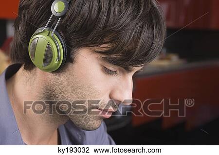 Man listening to headphones View Large Photo Image Stock Image - Man listening to headphones. Fotosearch