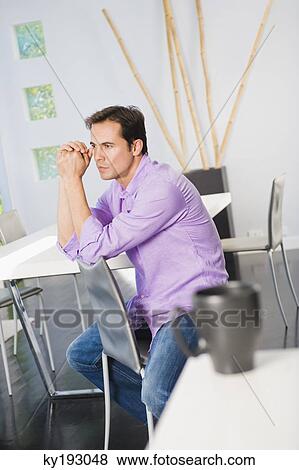 Man sitting on a chair and thinking View Large Photo Image Stock Photo - Man sitting on a chair and thinking. Fotosearch