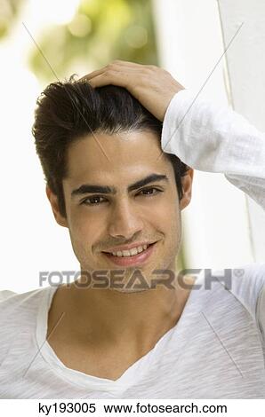 Portrait of a man with his hand in his hair View Large Photo Image Stock Photography - Portrait of a man with his hand in his hair. Fotosearch