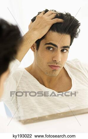 Reflection of a man in the mirror checking his hair View Large Photo Image Stock Image - Reflection of a man in the mirror checking his hair. Fotosearch